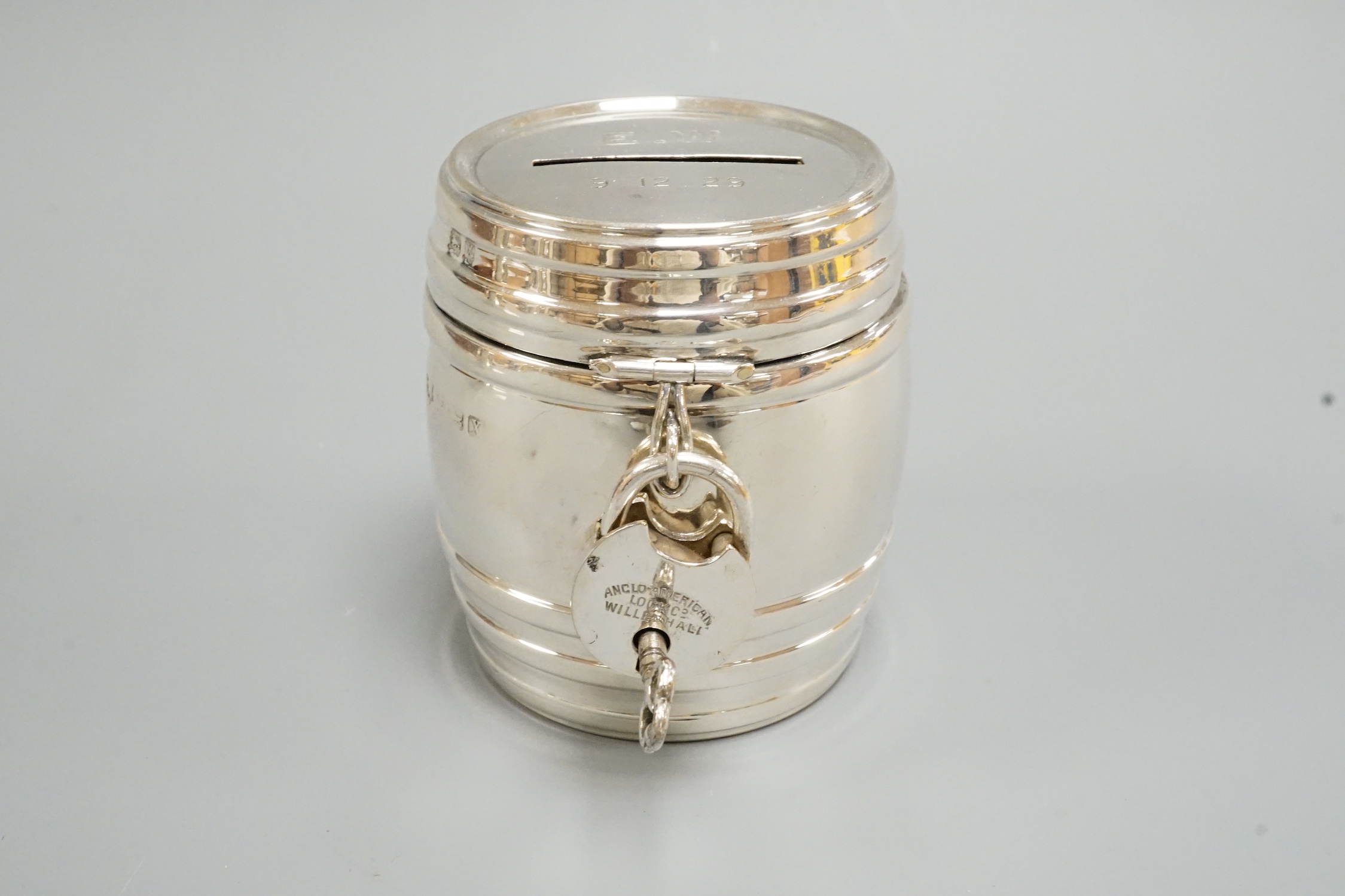 A George V silver barrel money box, with padlock & key, William Neale Ltd?, Birmingham, 1922, height 67mm.